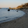 Photo of Blue Fish Cove coast line and ocean, with skyline in background.